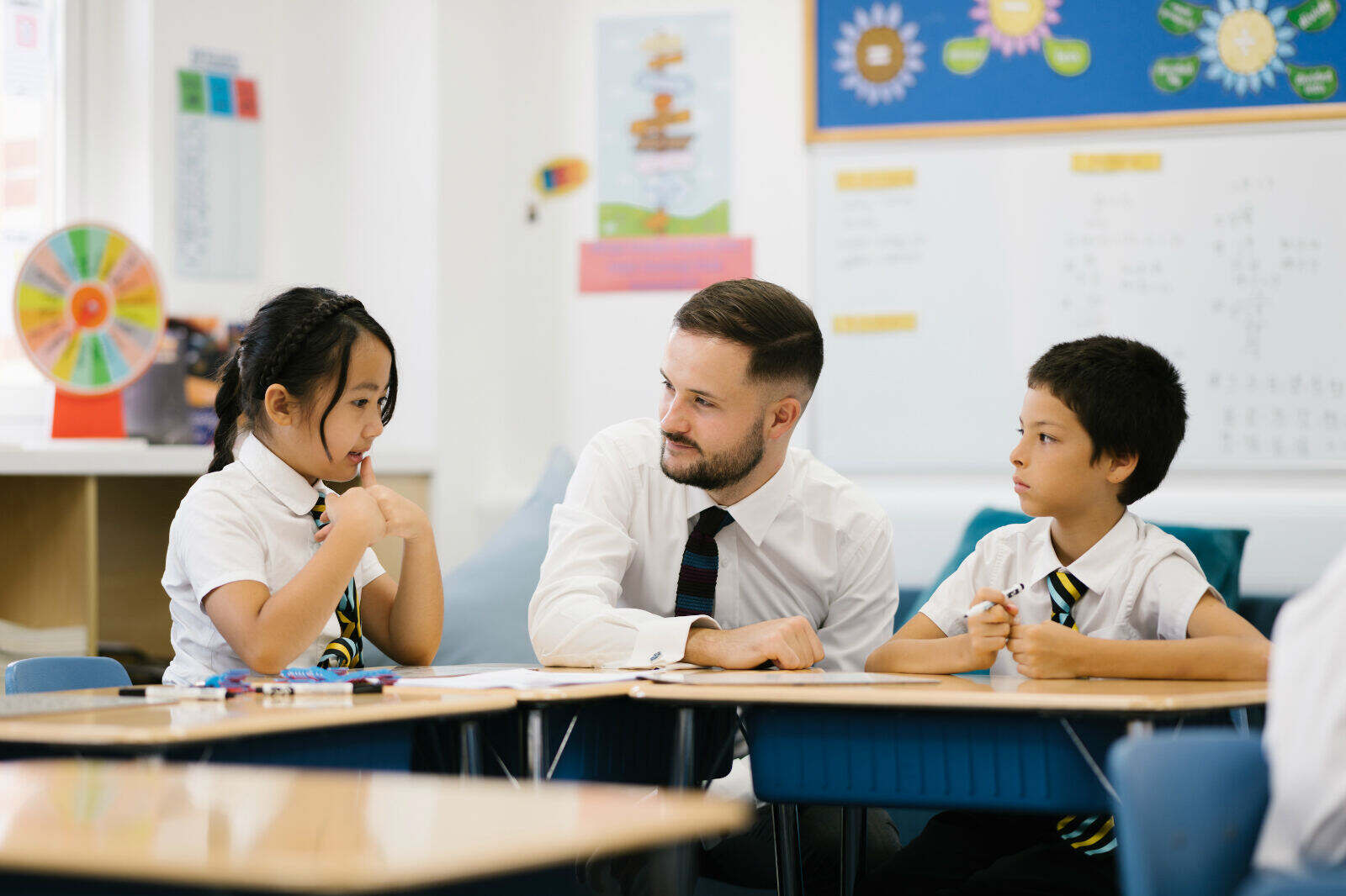 Teachers at Wellington College China share learnings and tips at a meeting, reflecting the professional growth and career development opportunities available at Wellington College China’s international schools.