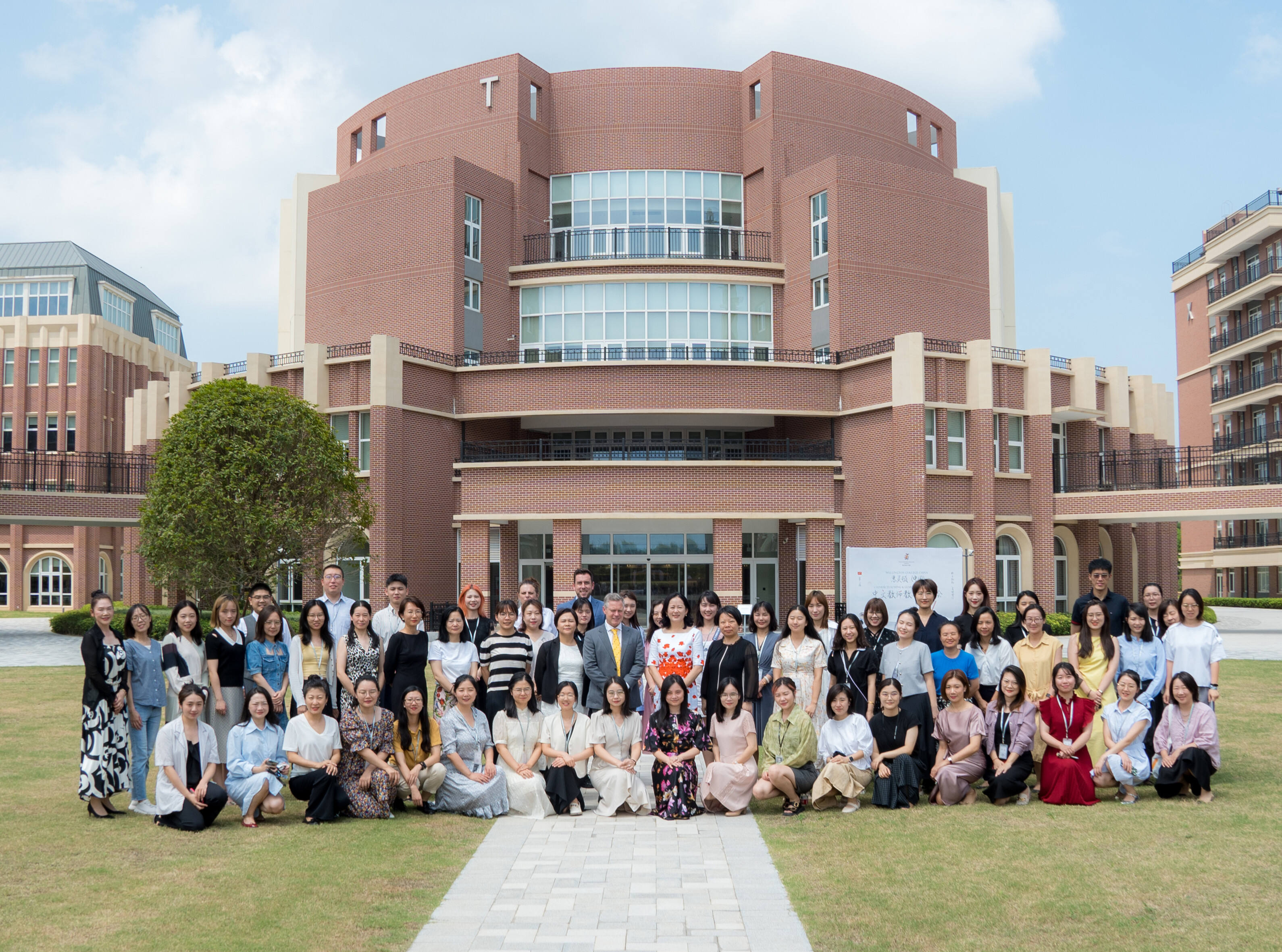 Teachers pose for a photo in front of Wellington College China after completing a teacher development programme to develop innovative education programmes, part of The Bridge | China initiative by Wellington College China.